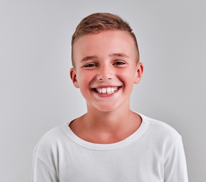 Smiling young boy wearing white t-shirt
