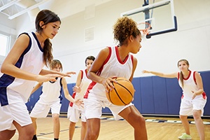 Teen girls playing basketball