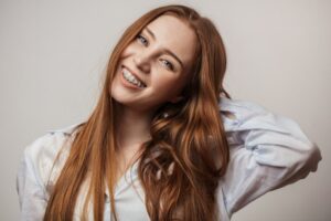 Woman smiling with clear braces