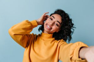 Woman with braces taking a selfie